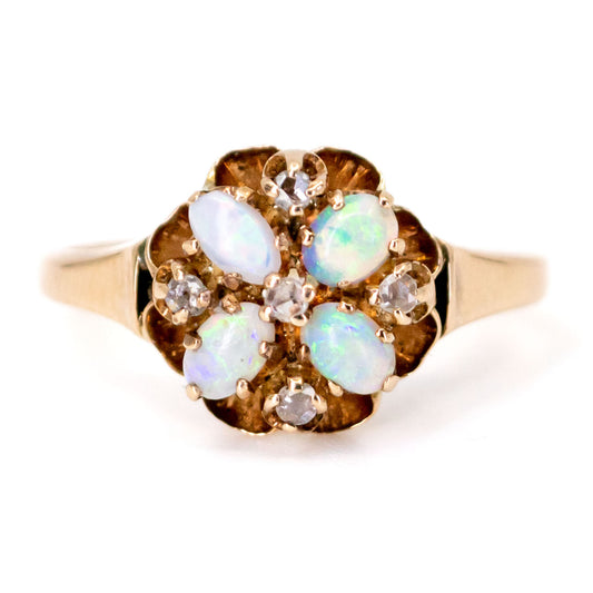 An opal and diamond ring in yellow gold