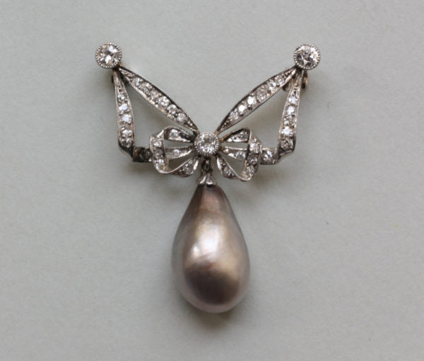 Antique Edwardian Old Cut Diamond, Natural Pearl and Platinum Bow Brooch; set with 39 single and old-cut diamonds, 12ct natural grey pearl drop, certified