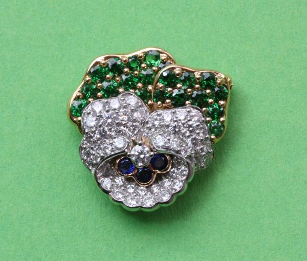 Vintage Tiffany and Co Diamond, Tsavorite Garnet and Sapphire Pansy Flower Brooch; set with 1.10ct tsavorite garnets and 2.10cts brilliant diamonds, Signed