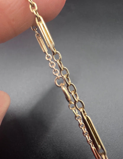 Close-up of stamps on yellow gold bracelet links