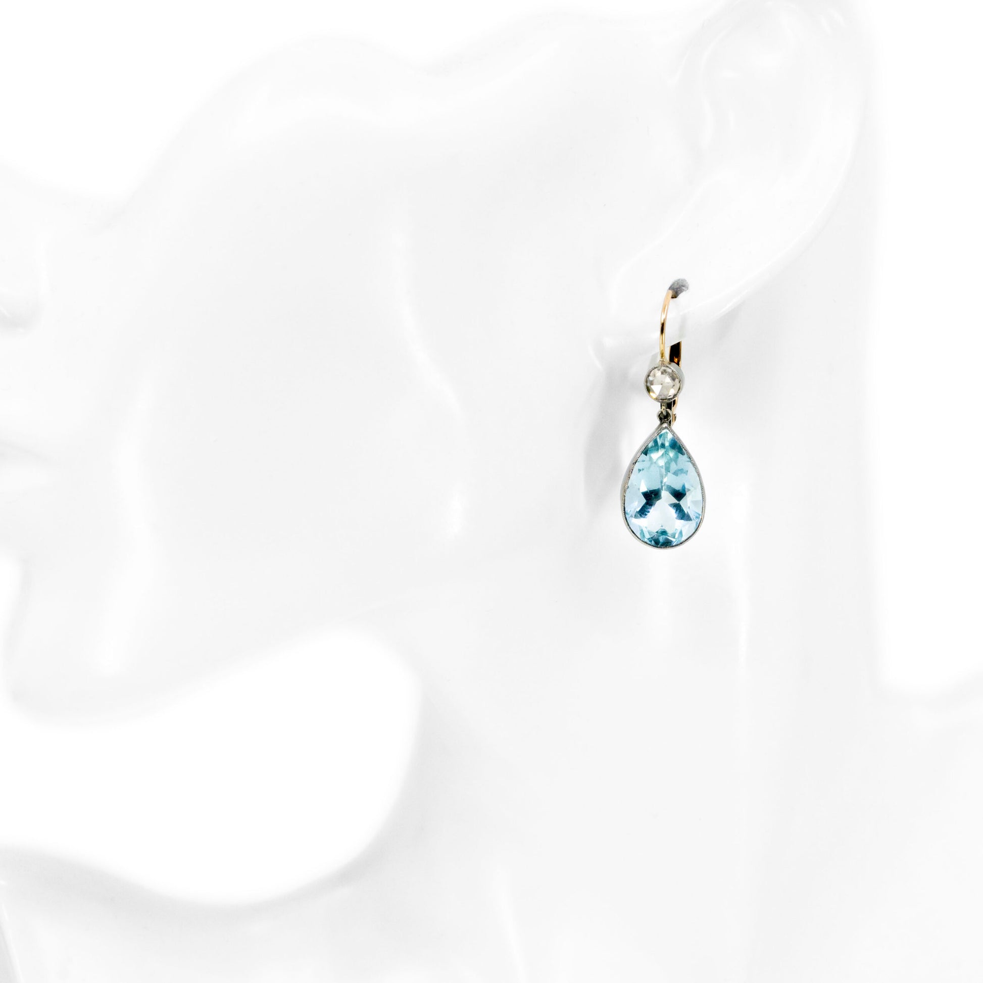 A pear cut aquamarine and rose cut diamond drop earring
