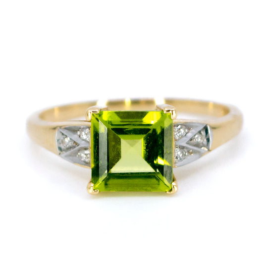 A square peridot ring with diamond shoulders in yellow and white gold
