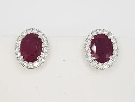 2.67ct Ruby and Diamond Oval Cluster Stud Earrings; oval faceted rubies encompassed by 0.55cts brilliant-cut diamonds, in 18ct white gold