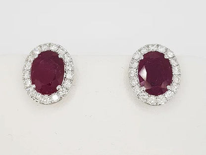 2.67ct Ruby and Diamond Oval Cluster Stud Earrings; oval faceted rubies encompassed by 0.55cts brilliant-cut diamonds, in 18ct white gold