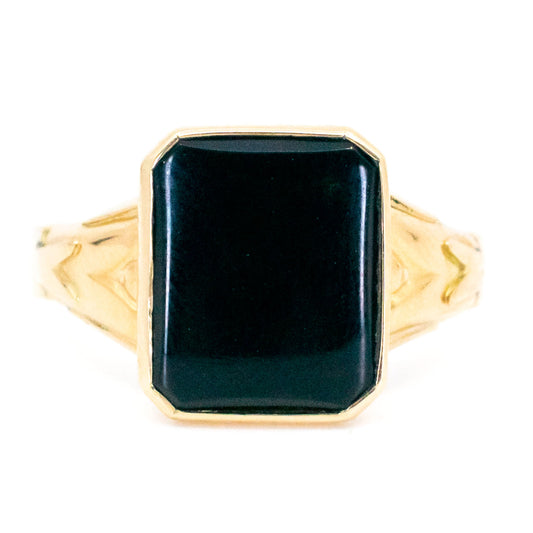 A black onyx signet ring in yellow gold