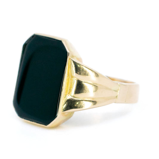 A black onyx signet ring in yellow gold