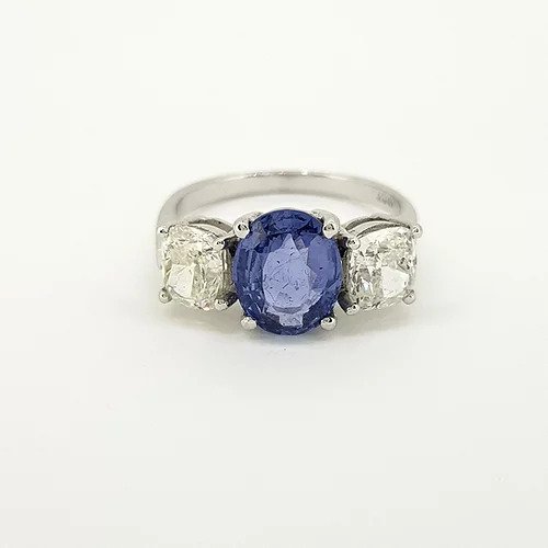 Madagascan Sapphire and Diamond Three Stone Trilogy Ring; central 2.52ct oval faceted Madagascan sapphire flanked by circular cut diamonds of approximately 1.00 carat each