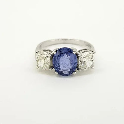 Madagascan Sapphire and Diamond Three Stone Trilogy Ring; central 2.52ct oval faceted Madagascan sapphire flanked by circular cut diamonds of approximately 1.00 carat each