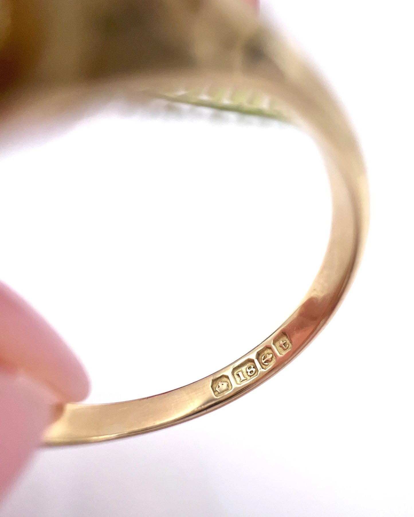 Close-up of an 18 carat gold hallmark inside a yellow gold ring shank