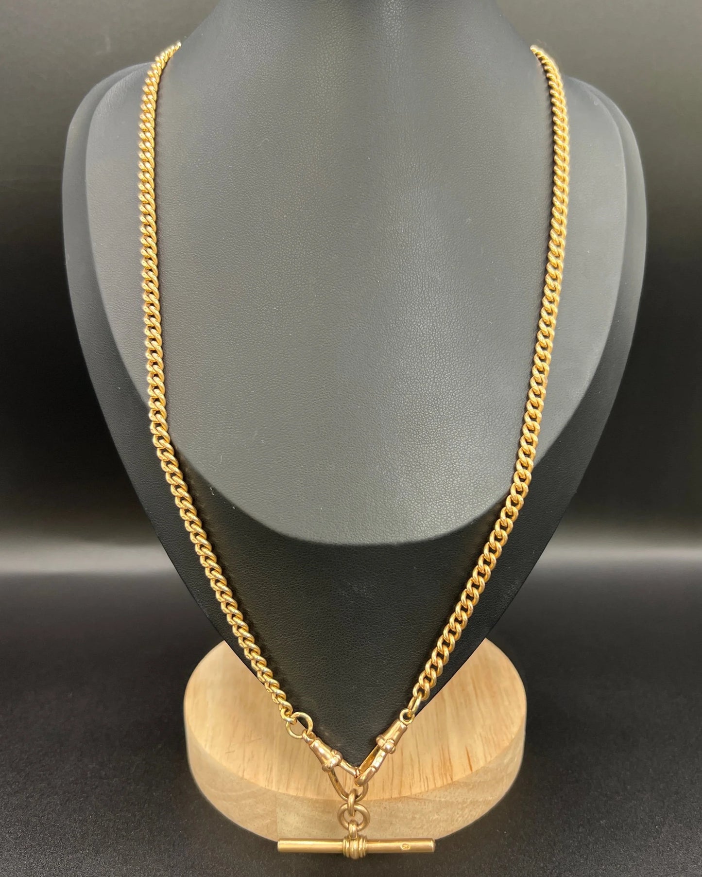 A gold curb link Albert chain, modelled on a black jewellery bust