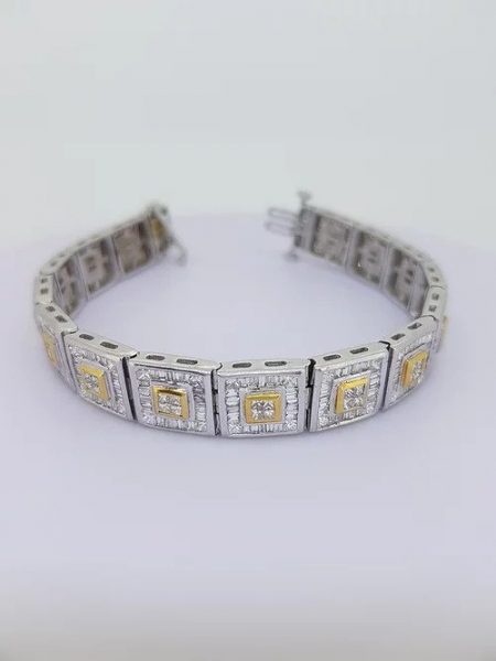 12.80ct Baguette Cut Diamond Link Bracelet; each square link comprises of a central brilliant-cut diamond cluster within a yellow gold setting, all within a baguette-cut diamond surround, in 18ct white gold, 12.80 carat total