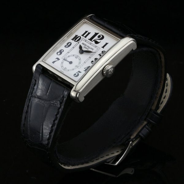 Patek Philippe 18ct White Gold Manual Winding Watch; 29mm 18ct white gold case with white porcelain dial and black Arabic hour markers, on an original Patek Philippe leather strap with an 18ct white gold Patek Philippe buckle, with certificate and Patek Philippe travel pouch