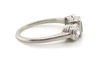 Princess Cut Colombian Emerald and Diamond Three Stone Ring; central 0.50 carats modified square-cut emerald of intense colour set in-between two old European transitional cut diamonds totalling 0.66 carats, in platinum