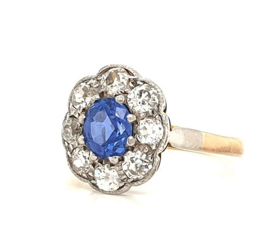 Antique Ceylon Sapphire and Old Cut Diamond Cluster Ring; 0.80ct oval cornflour blue sapphire surrounded by 0.80cts old mine cut diamonds, Circa 1900