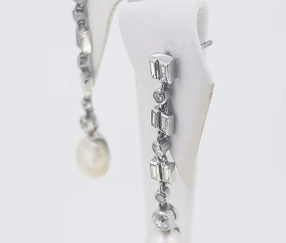 Natural Pearl and Diamond Drop Earrings; natural saltwater pearls suspended from baguette and brilliant-cut diamond set drops, 18ct white gold. With certificate