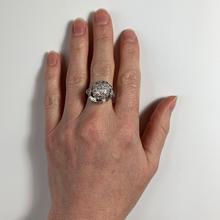 Vintage Diamond and Platinum Domed Cocktail Ring; central dome encrusted with brilliant diamonds, with a curve of tapered baguette diamonds and diamond set shoulders, 3.72 carat total. Numbered 995644