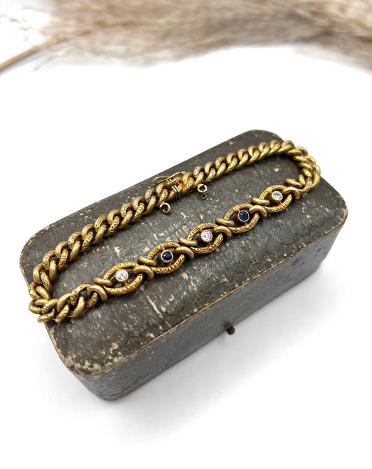 A sapphire and diamond fancy curb link bracelet in yellow gold