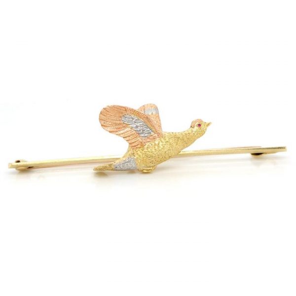 Antique Flying Grouse Brooch, crafted from 15ct yellow and rose gold and platinum, with a red gemstone eye, Circa 1930s