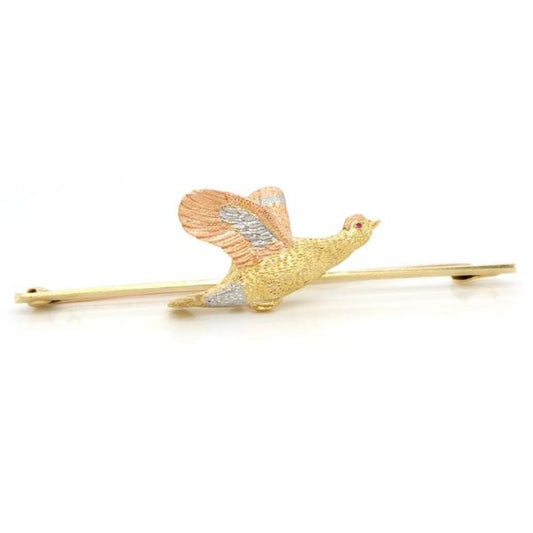 Antique Flying Grouse Brooch, crafted from 15ct yellow and rose gold and platinum, with a red gemstone eye, Circa 1930s