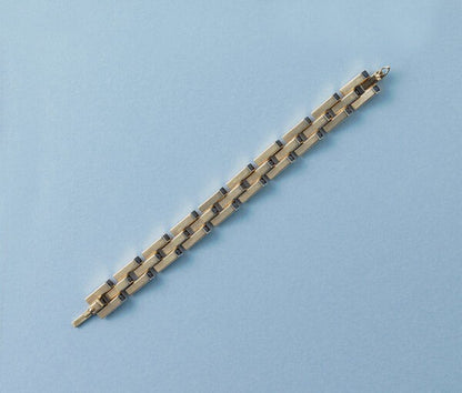 Cartier Gold Retro Bracelet Set With Sapphires; industrial design tank link gold bracelet set with thirty-one French square cut sapphires, Signed and numbered, Circa 1940