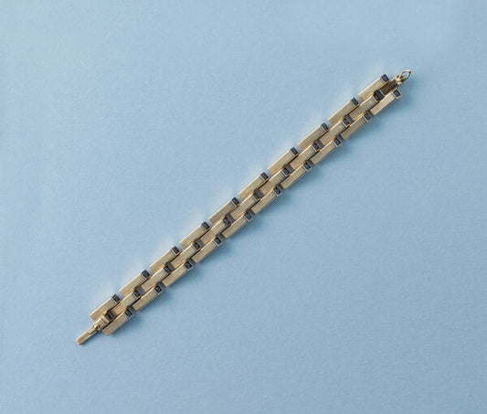 Cartier Gold Retro Bracelet Set With Sapphires; industrial design tank link gold bracelet set with thirty-one French square cut sapphires, Signed and numbered, Circa 1940