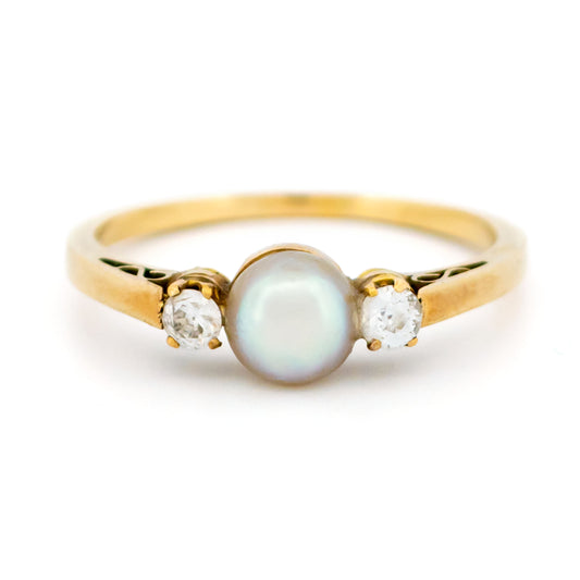 A three stone pearl and diamond ring in yellow gold