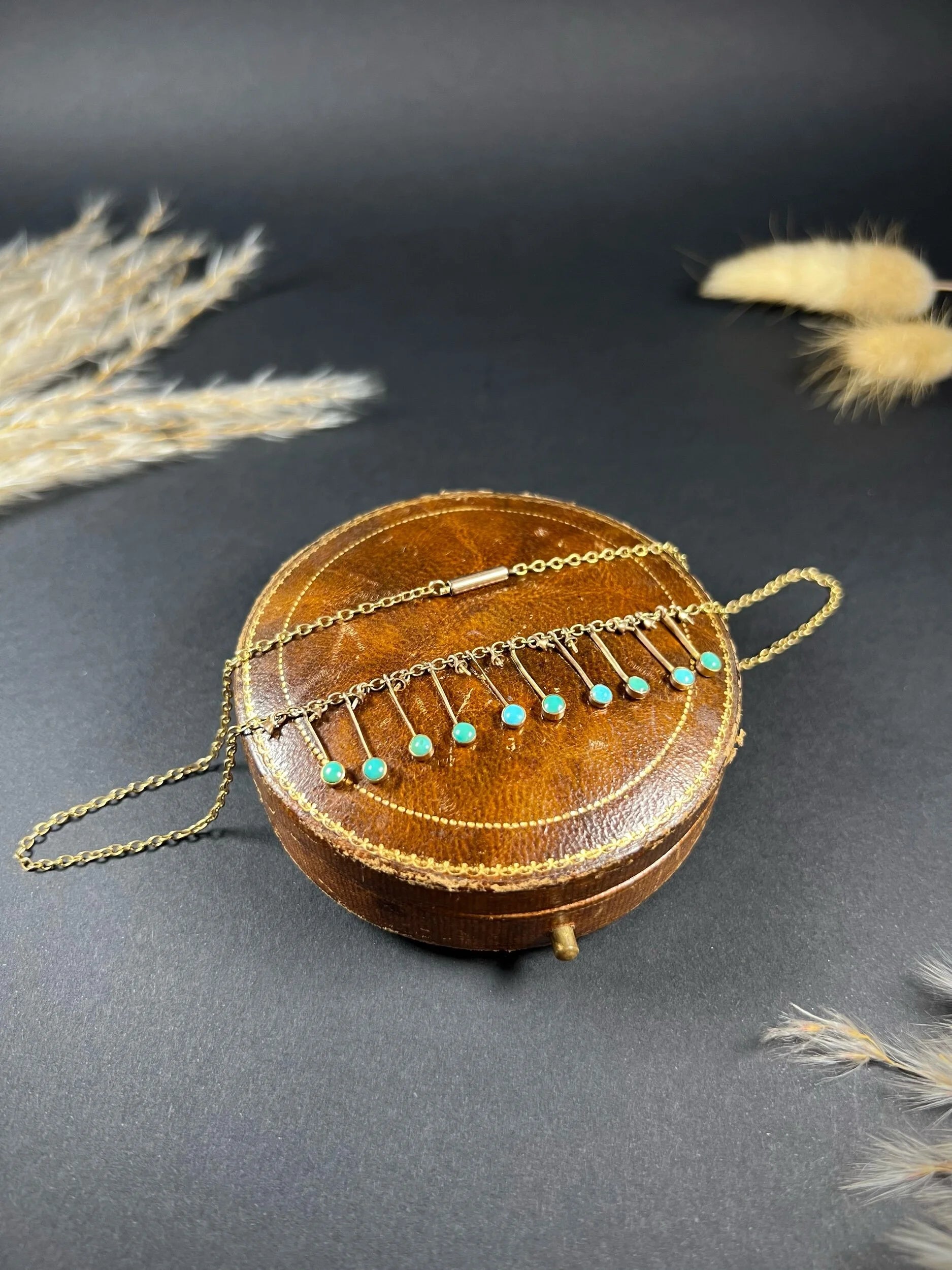 A gold negligee pendant necklace with turquoise drops