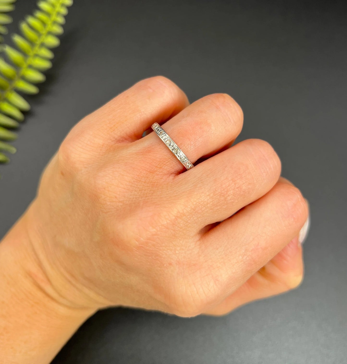 A diamond full eternity ring in white gold, modelled on a hand