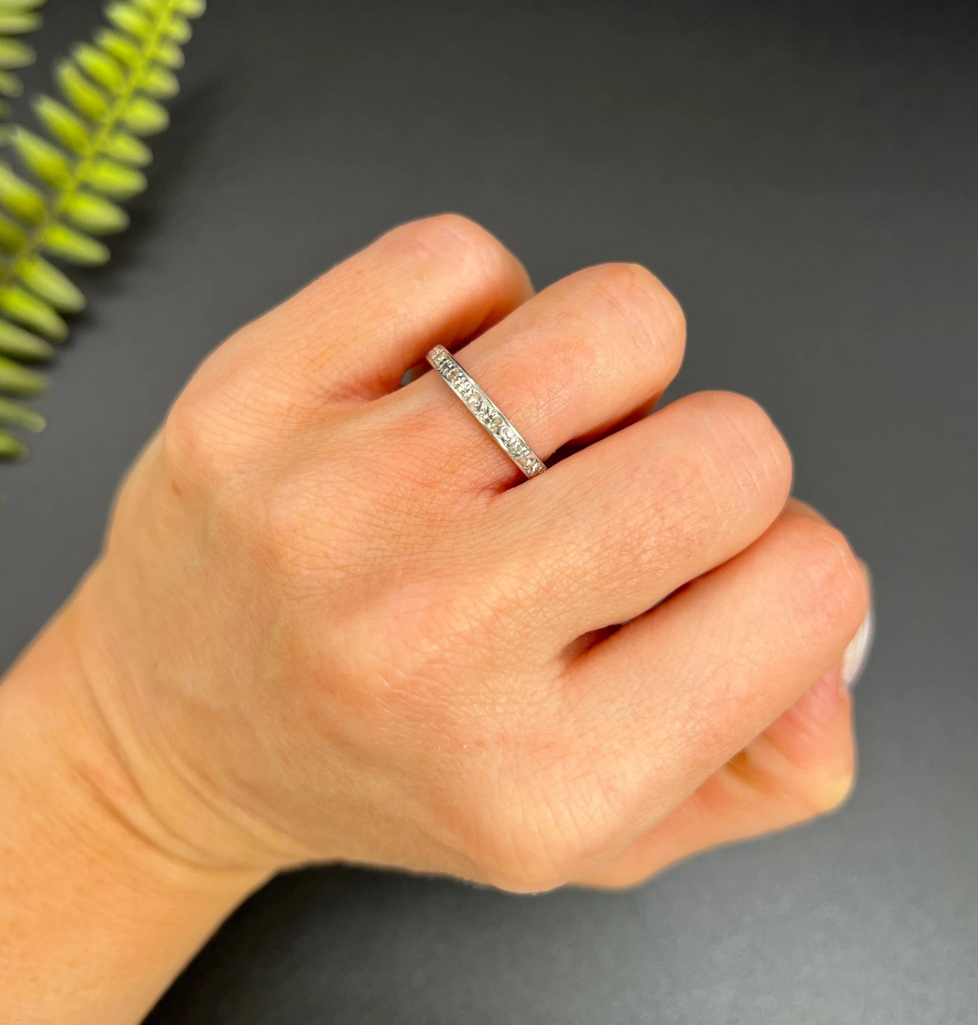 A diamond full eternity ring in white gold, modelled on a hand