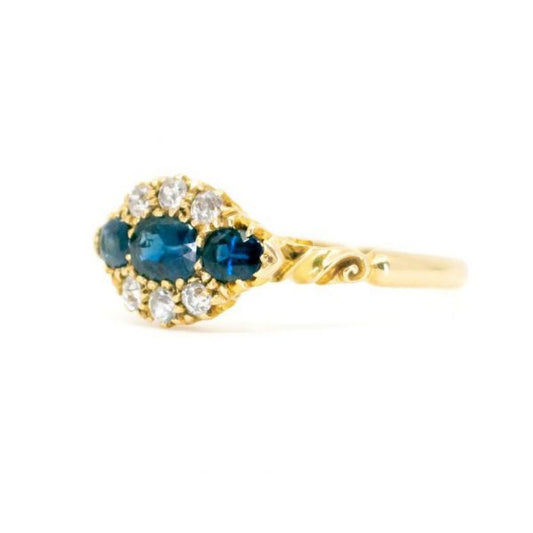 Antique Victorian Sapphire and Old Cut Diamond Ring; three sapphires surrounded by old mine-cut diamonds, 1.18 carat total, set in 18ct yellow gold.