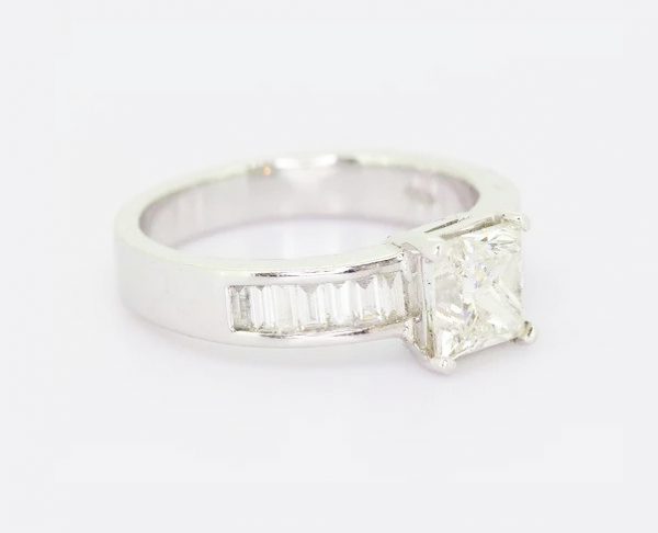 Princess Cut Diamond Engagement Ring; 1.70ct princess-cut diamond, four-claw set, accented with 0.57ct baguette-cut diamond set shoulders, 18ct white gold.