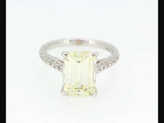 Exquisite Emerald cut solitaire diamond weighing 4.14 carats set with round brilliant cut diamond shoulders totaling 0.24 carats, 18ct white gold. 