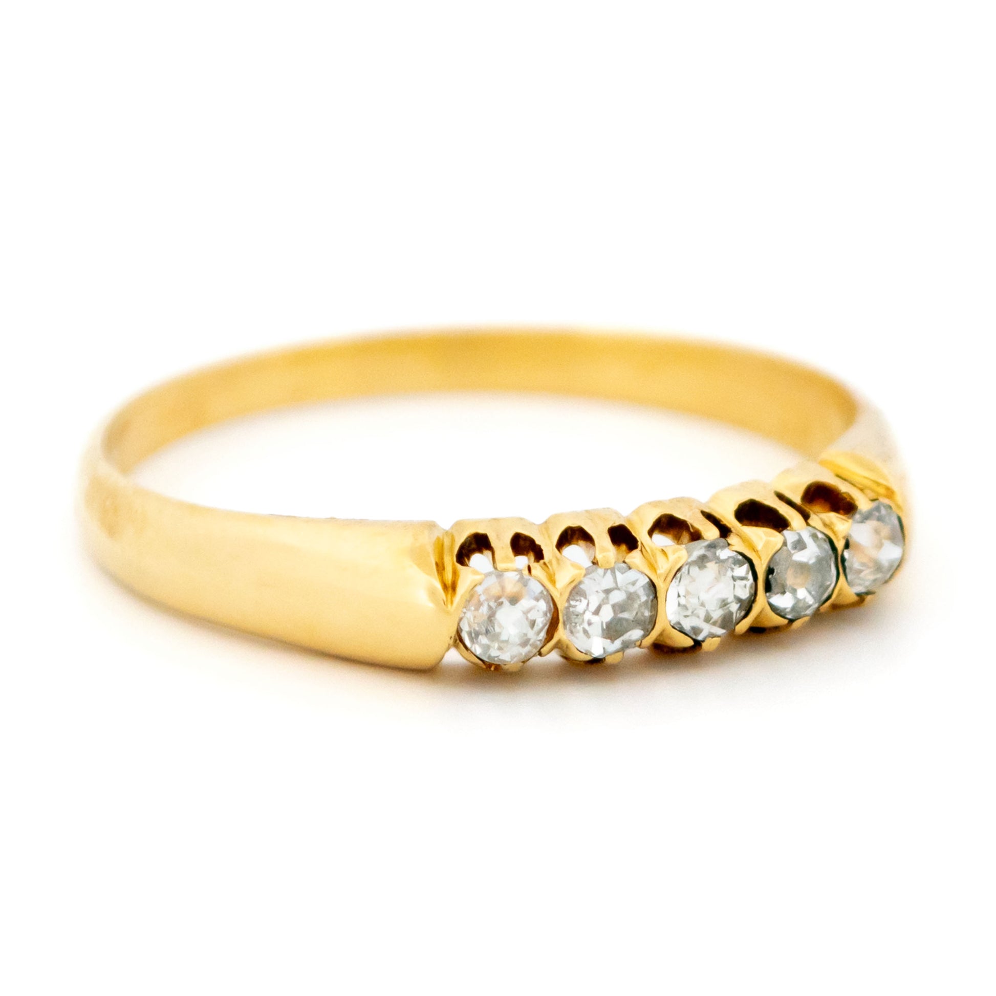 A five stone diamond ring in yellow gold