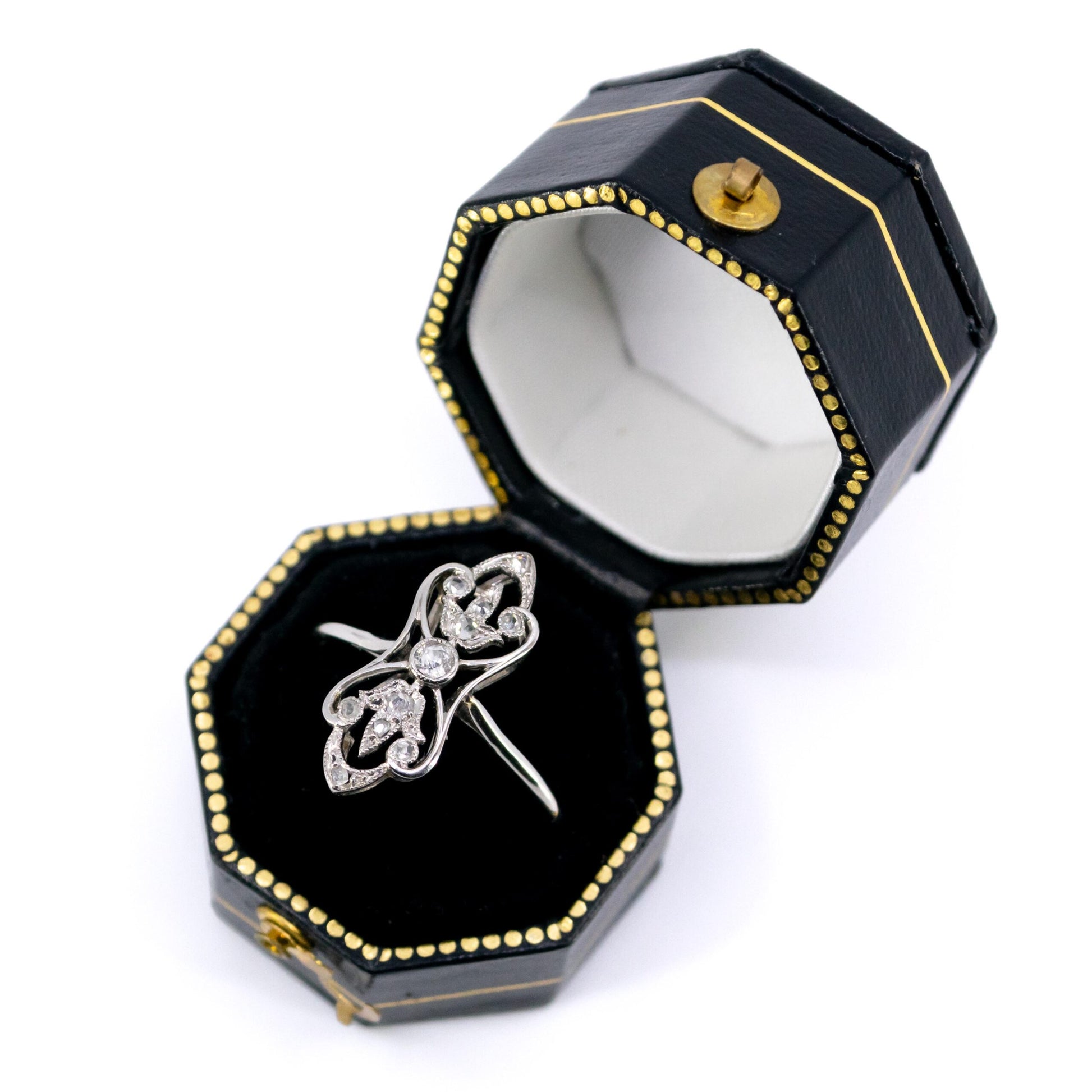 A diamond elongated ring in platinum, in a ring box