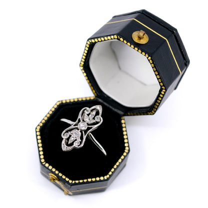 A diamond elongated ring in platinum, in a ring box