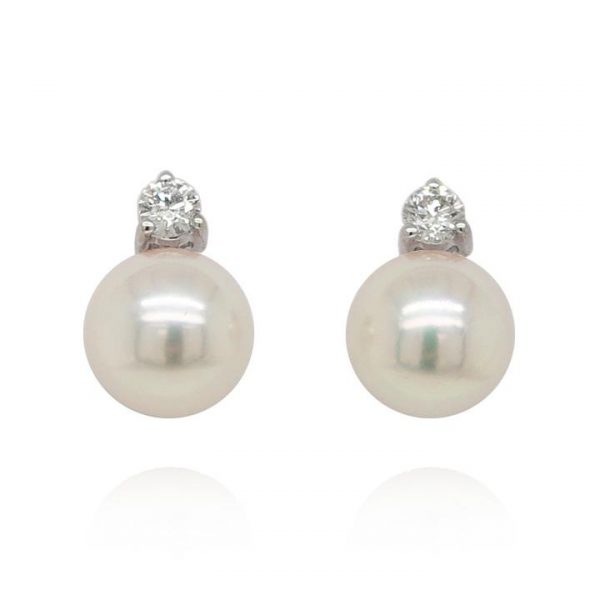 Akoya Pearl and Diamond Earrings; featuring round Akoya cultured pearls topped with 0.20cts diamond studs. Mounted in 18ct white gold, with post and butterfly fittings