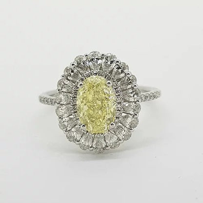 Fancy Yellow Diamond Cluster Ring with GIA Certificate; 1.59ct Oval Fancy Yellow GIA certified Natural Diamond surrounded by 0.15cts brilliant white diamonds and an outer border of 0.90cts pear-shaped diamonds, giving a scalloped edge finish, mounted in platinum