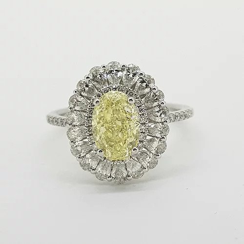 Fancy Yellow Diamond Cluster Ring with GIA Certificate; 1.59ct Oval Fancy Yellow GIA certified Natural Diamond surrounded by 0.15cts brilliant white diamonds and an outer border of 0.90cts pear-shaped diamonds, giving a scalloped edge finish, mounted in platinum