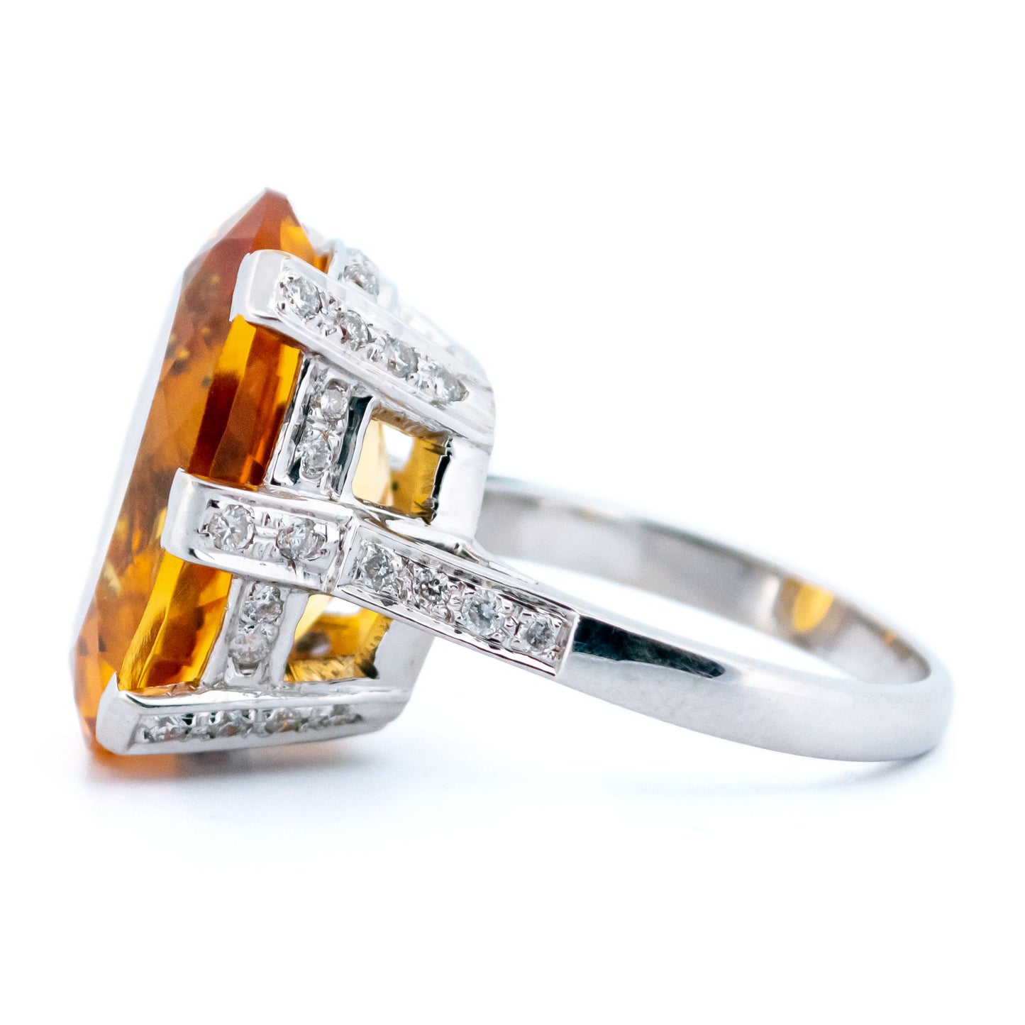 A large statement ring featuring an oval citrine with diamond shoulders in white gold