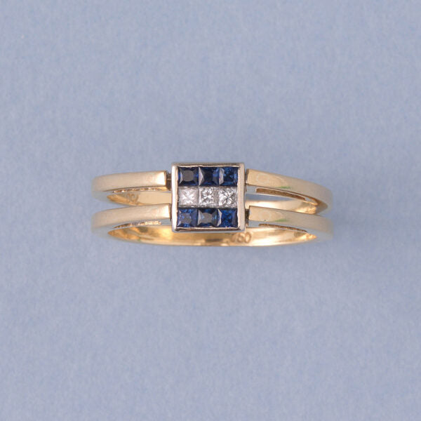 Vintage Princess Cut Diamond Reversible Ring with Sapphires or Rubies; once side set with six princess-cut sapphires in two rows flanking a line of princess-cut diamonds in the middle, the other side set with six-princess cut diamonds in two rows flanking a line of princess-cut rubies, in 18ct gold, Italy, Circa 1980