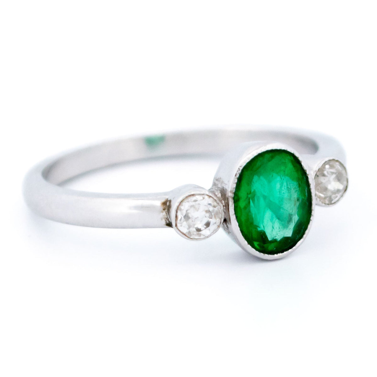 Vintage 14 Carat White Gold Oval Emerald and Old Mine-Cut Diamond Three Stone Ring