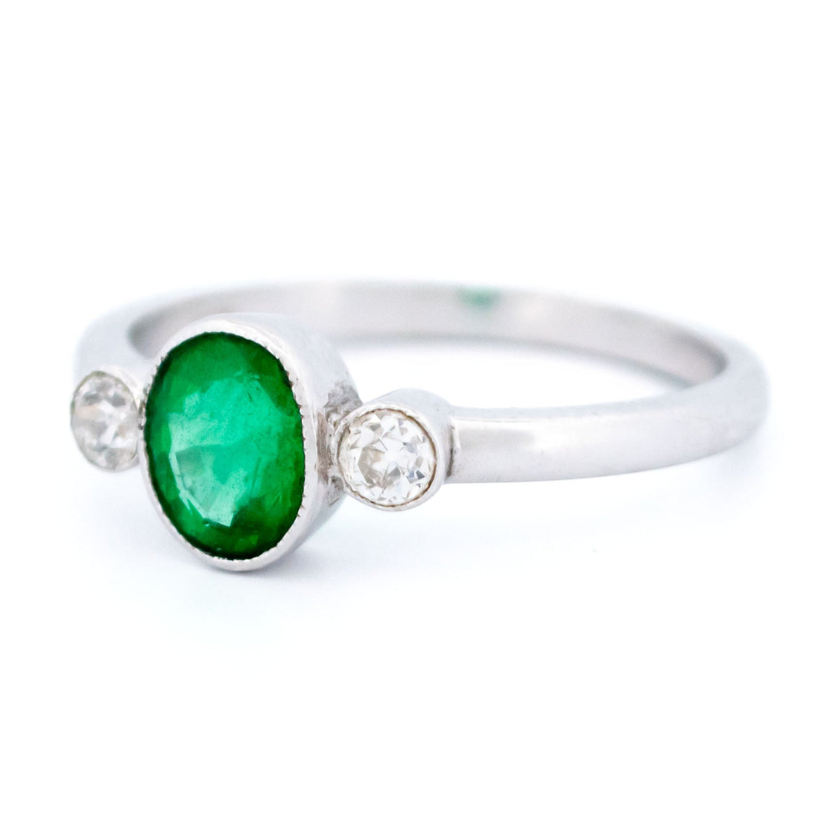 Vintage 14 Carat White Gold Oval Emerald and Old Mine-Cut Diamond Three Stone Ring