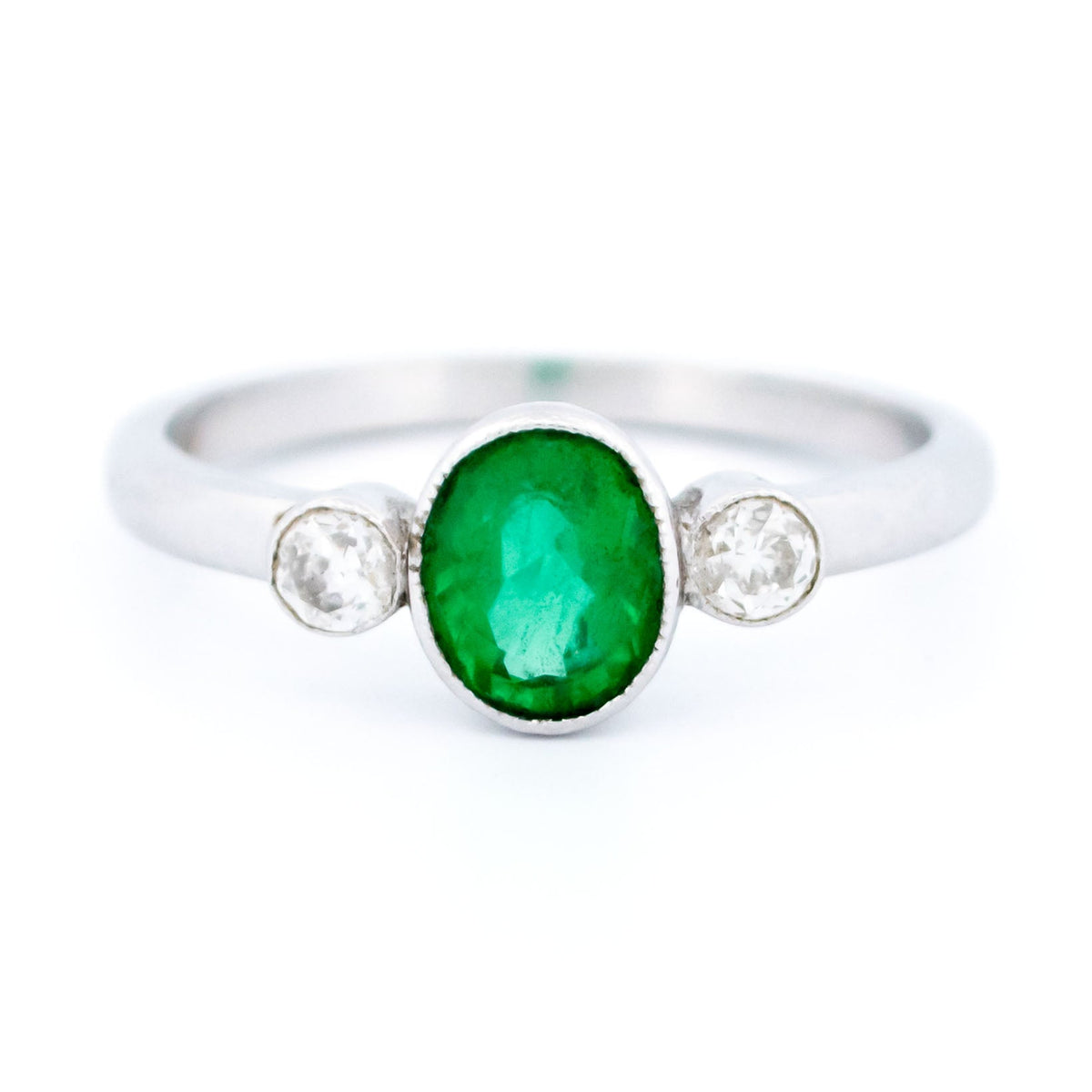 Vintage 14 Carat White Gold Oval Emerald and Old Mine-Cut Diamond Three Stone Ring