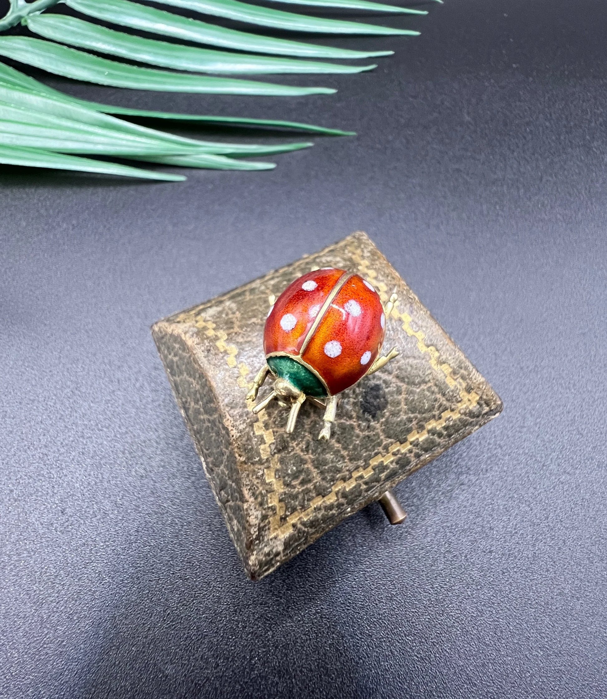 A yellow gold and enamel ladybird brooch
