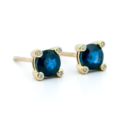 A pair of round sapphire and diamond stud earrings in yellow gold