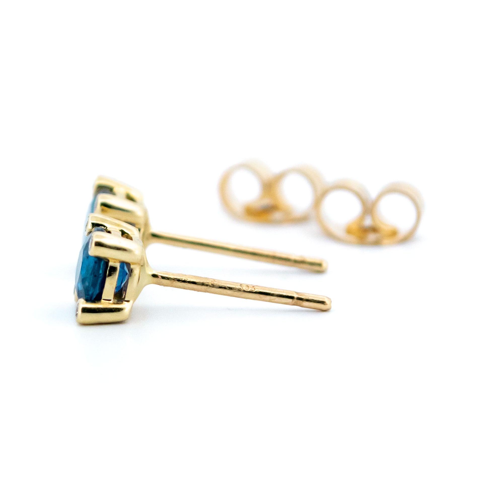 A pair of round sapphire and diamond stud earrings in yellow gold