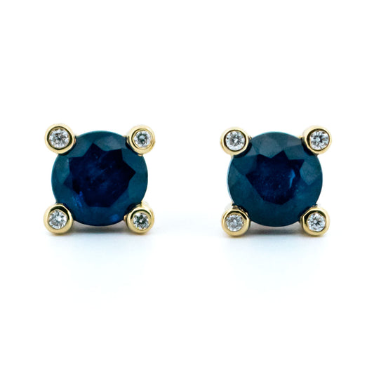 A pair of round sapphire and diamond stud earrings in yellow gold