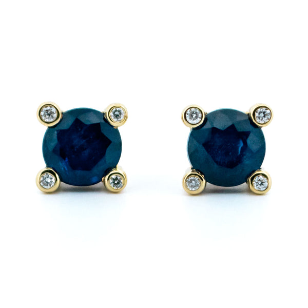 A pair of round sapphire and diamond stud earrings in yellow gold