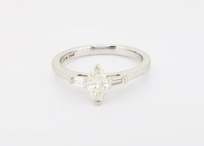 Marquise Cut Diamond Engagement Ring; set with a 0.45ct marquise-cut diamond flanked by 0.13ct baguette-cut diamond set shoulders, 18ct white gold.