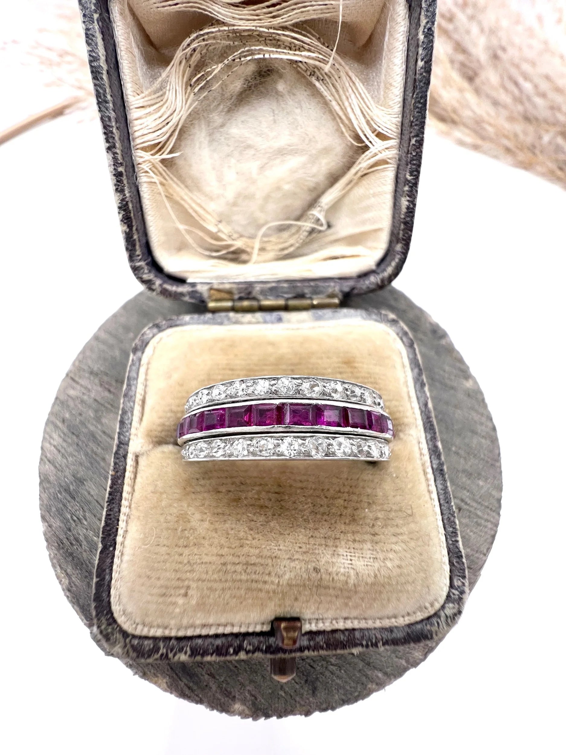A platinum night and day flip band ring set with diamonds, sapphires and rubies, in a ring box